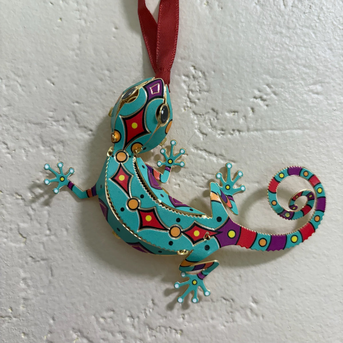 Turquoise Lizard Holiday Ornament against white stucco backdrop For Sale Online 