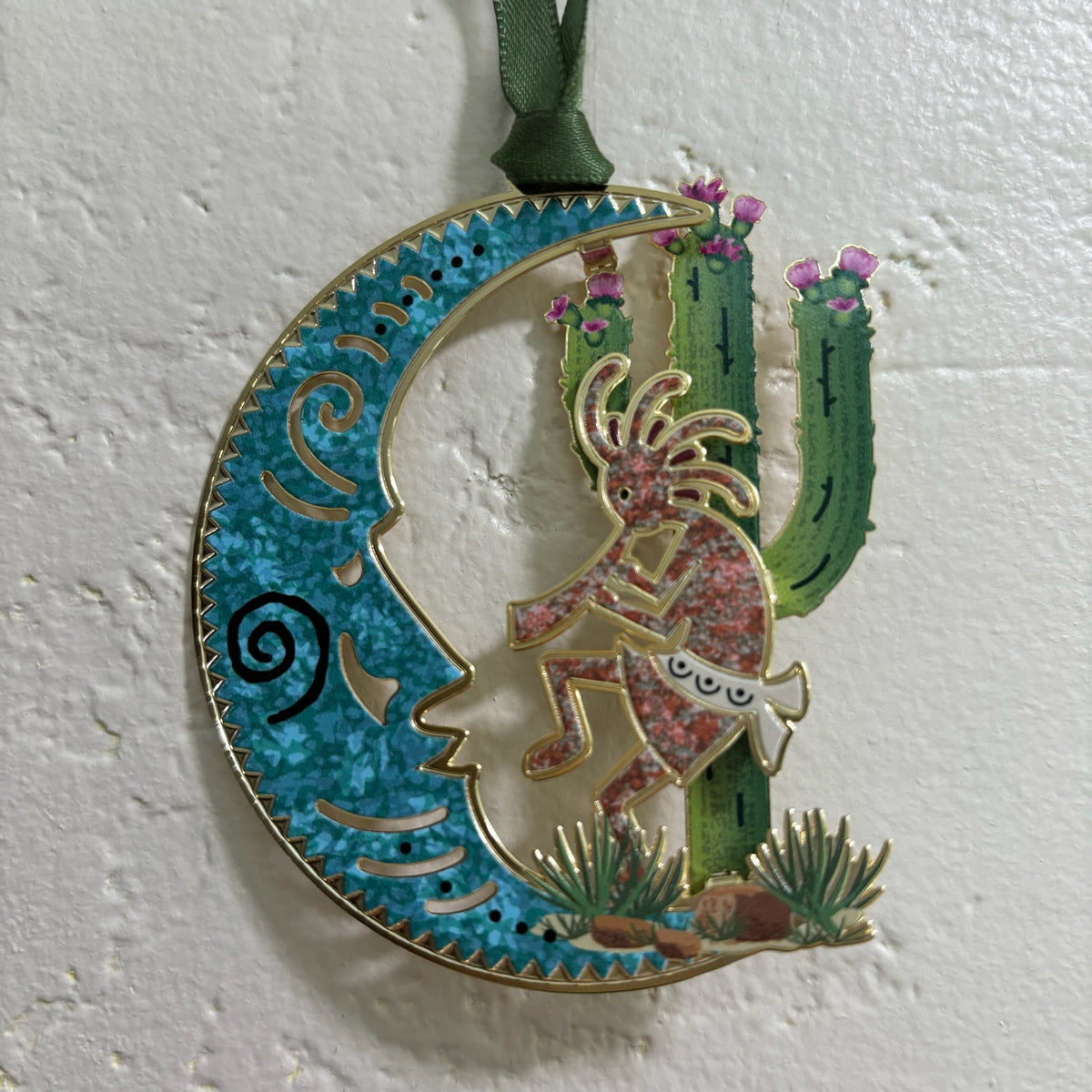 Kokopelli Holiday Ornament Christmas Ornament against white stucco backdrop For Sale Online