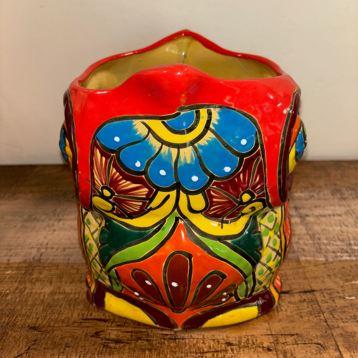 Side view Hand-made Hand-painted colorful red Owl Talavera pottery from Mexico for sale online with Aloe succulent planted in it.  